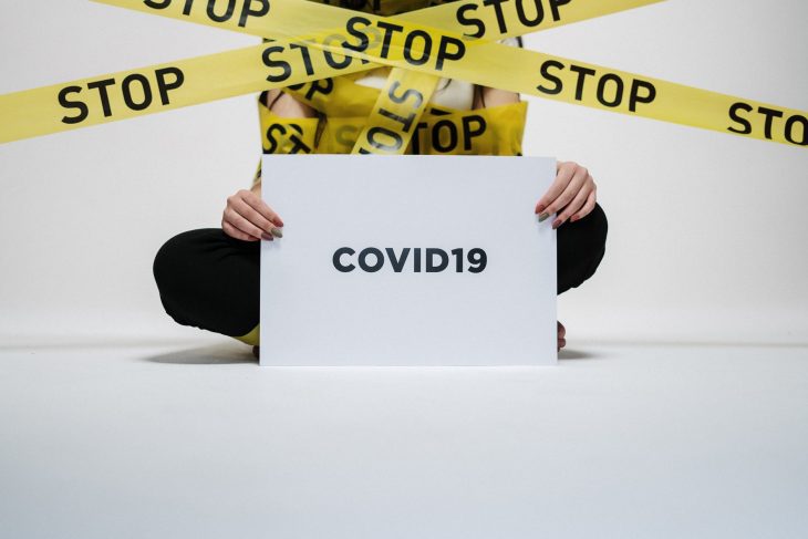 person holding covid sign